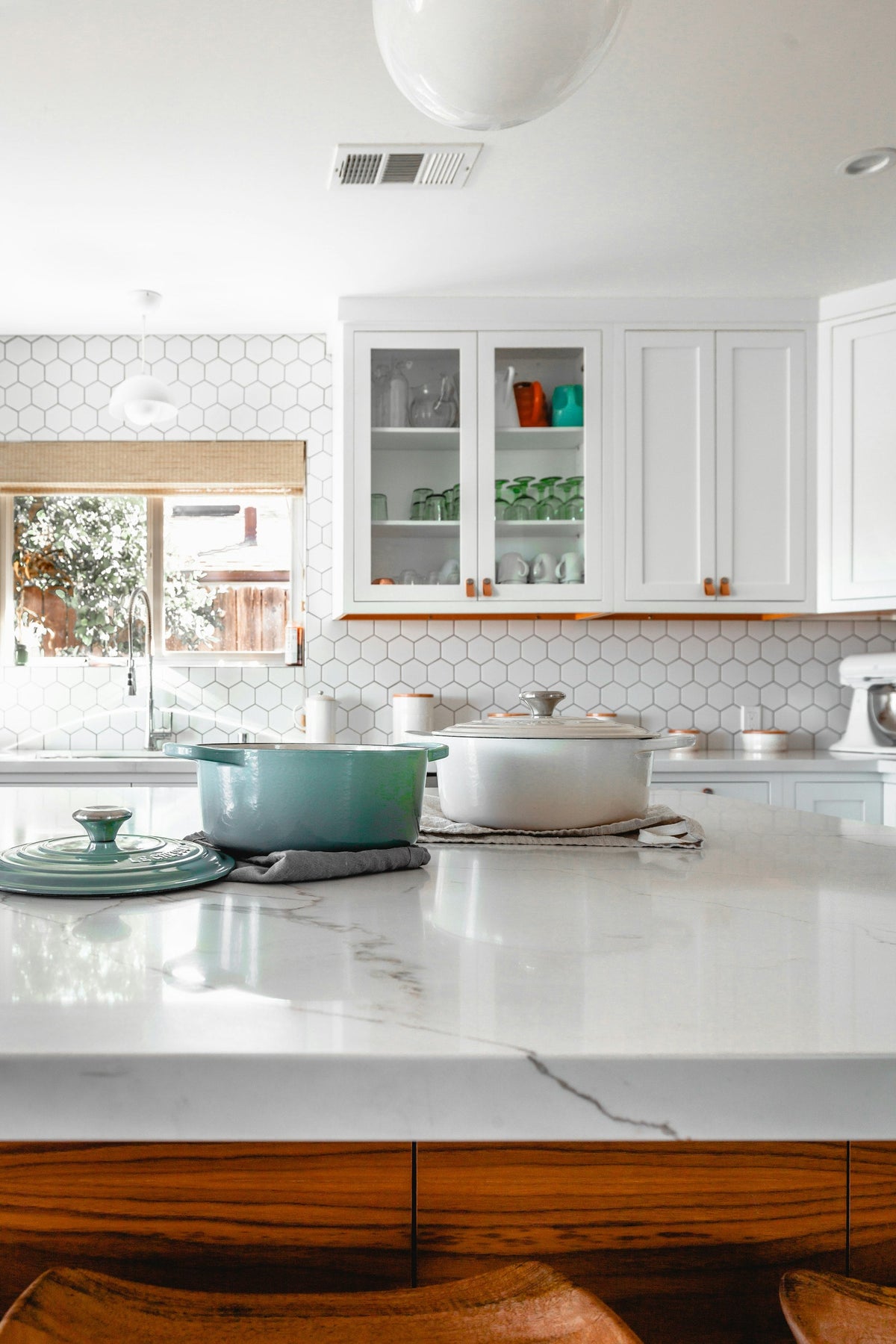 Two cooking pots on a kitchen island